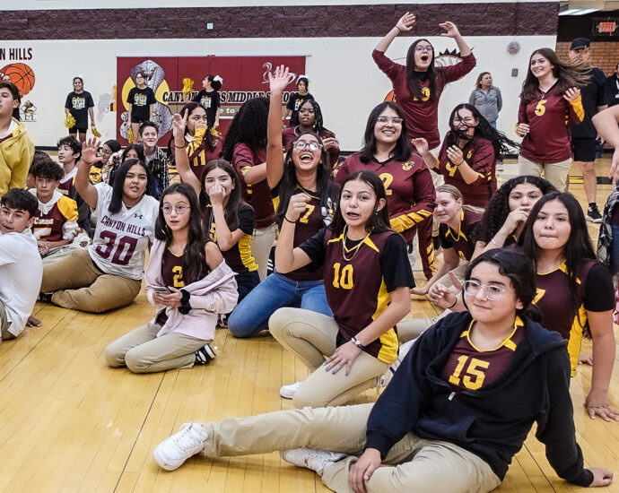 Group of teens in gymnasium.